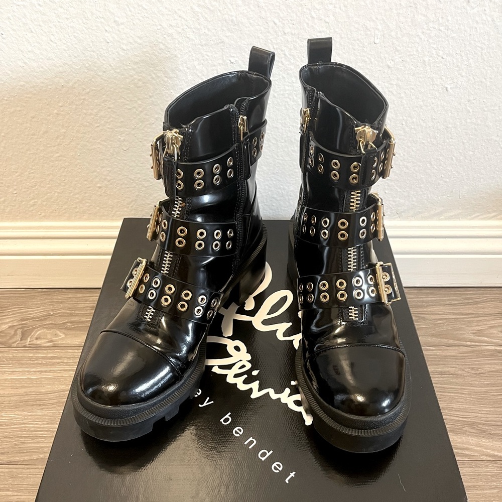 Black boots with gold buckles from Alice + Olivia.